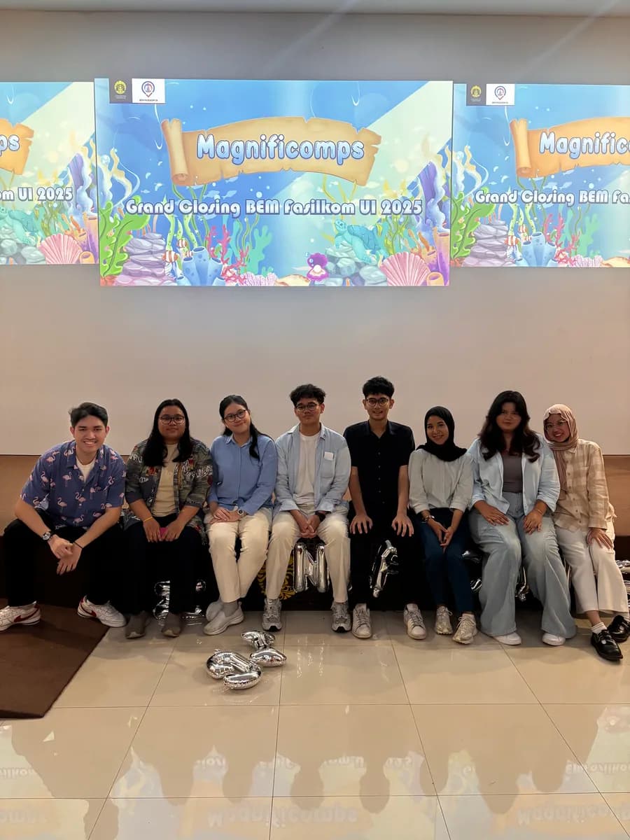 Wahyu and friends seated together at an indoor event