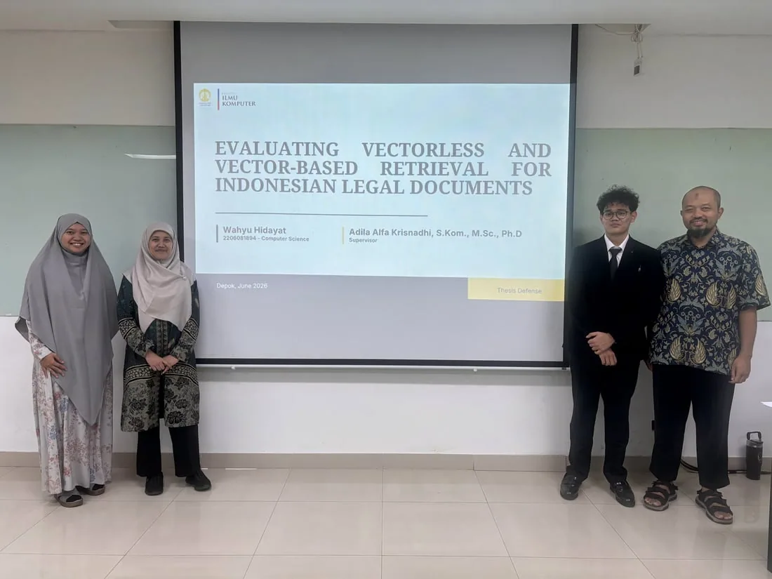 Wahyu with his thesis examining committee after the defense