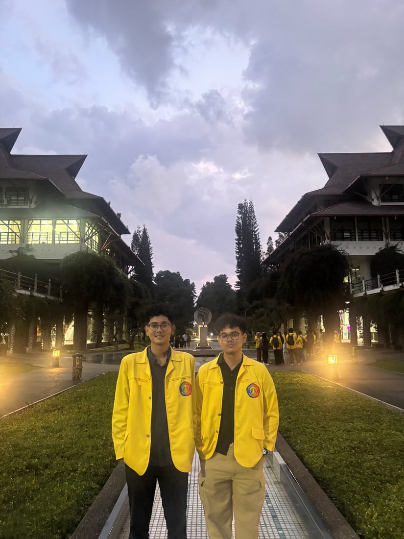 Wahyu and a friend on Universitas Indonesia campus at dusk